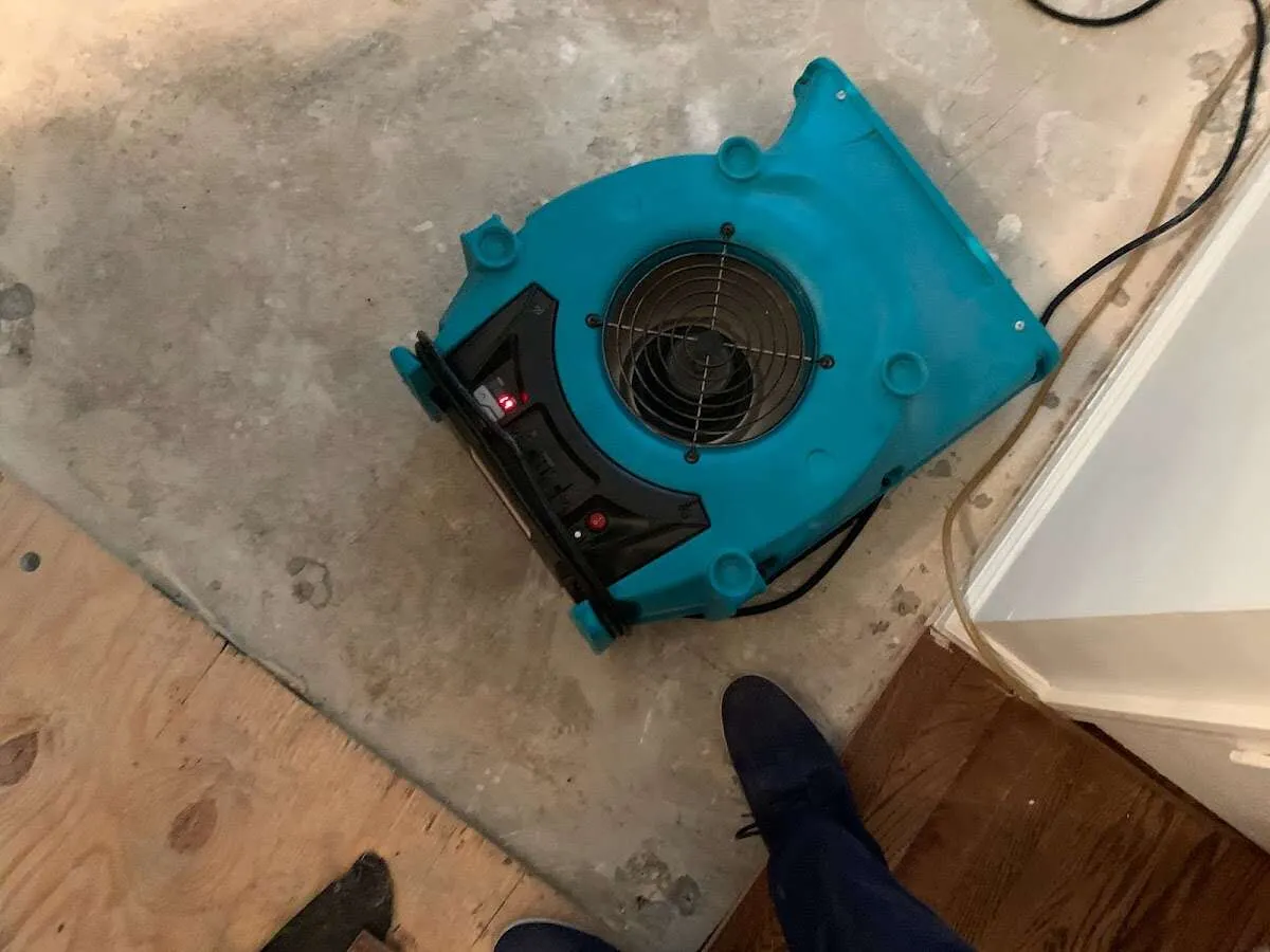 Air mover drying subfloor during Leak Detection & Repair in Granite City